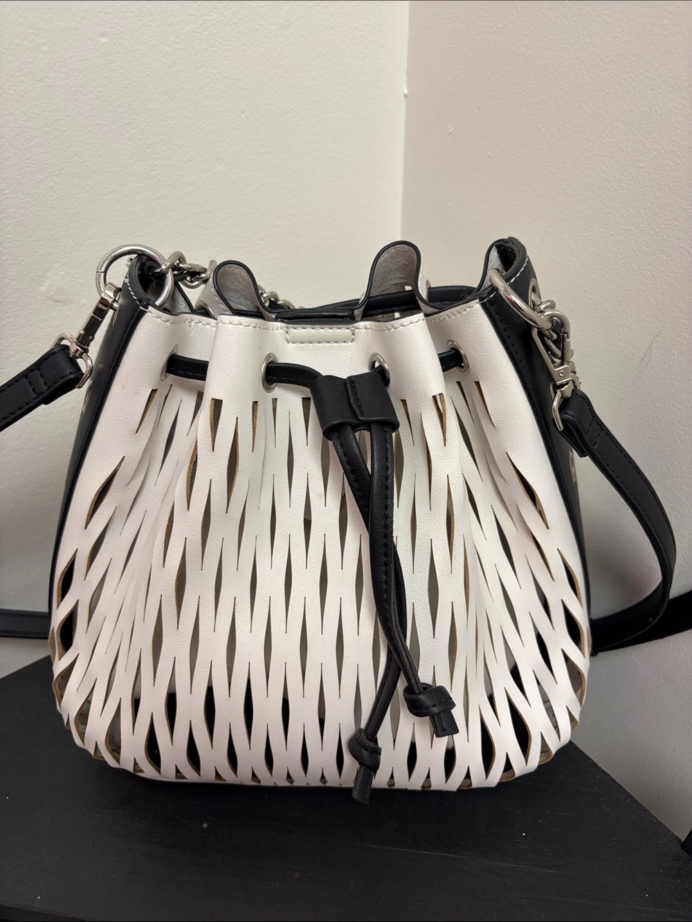 White & Black Laser-Cut Drawstring Crossbody Bag